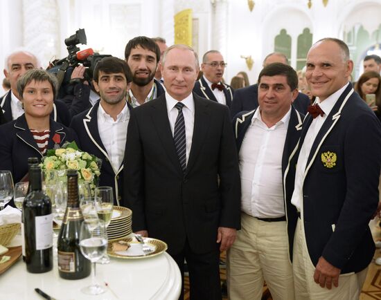 President Vladimir Putin gives government awards to Olympic medalists