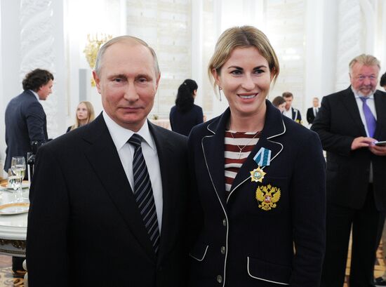 President Vladimir Putin gives government awards to Olympic medalists