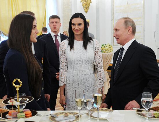 President Vladimir Putin gives government awards to Olympic medalists