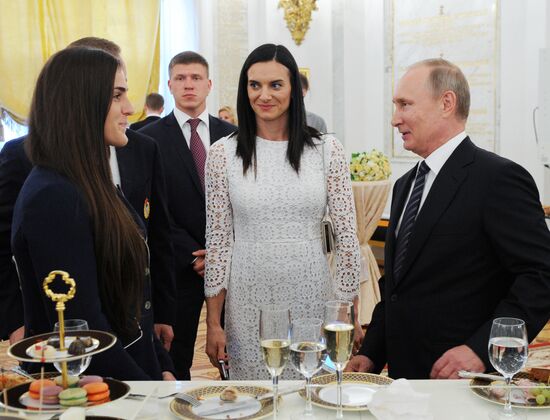 President Vladimir Putin gives government awards to Olympic medalists