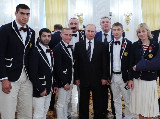 President Vladimir Putin gives government awards to Olympic medalists