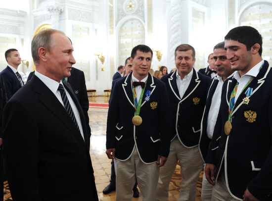 President Vladimir Putin gives government awards to Olympic medalists