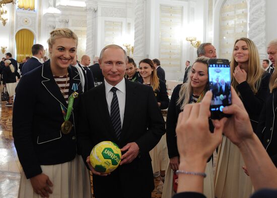 President Vladimir Putin gives government awards to Olympic medalists