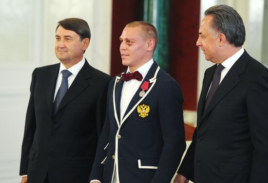 President Vladimir Putin gives government awards to Olympic medalists