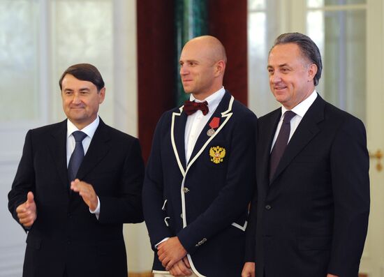 President Vladimir Putin gives government awards to Olympic medalists