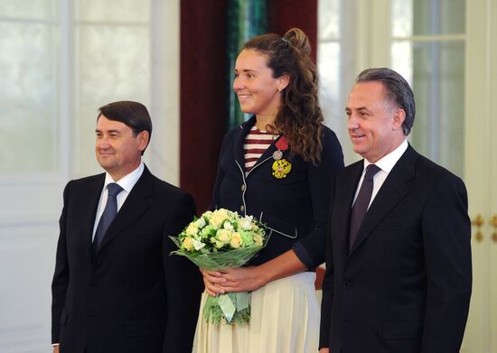 President Vladimir Putin gives government awards to Olympic medalists