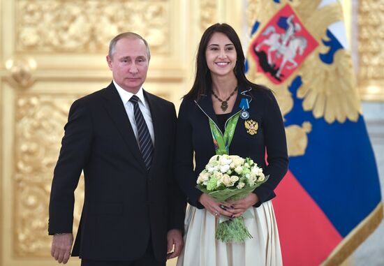 President Vladimir Putin gives government awards to Olympic medalists