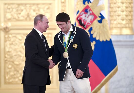 President Vladimir Putin gives government awards to Olympic medalists