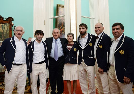 President Vladimir Putin gives government awards to Olympic medalists