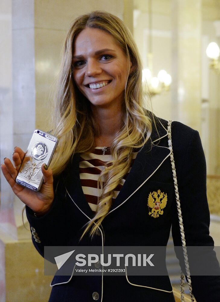 President Vladimir Putin gives government awards to Olympic medalists