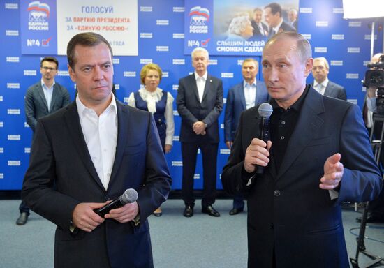 Vladimir Putin and Dmitry Medvedev visit United Russia party's election campaign headquarters