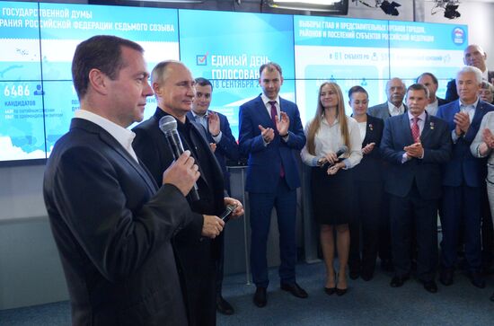 Vladimir Putin and Dmitry Medvedev visit United Russia party's election campaign headquarters