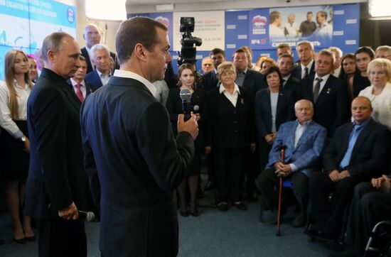 Vladimir Putin and Dmitry Medvedev visit United Russia party's election campaign headquarters