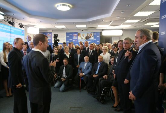 Vladimir Putin and Dmitry Medvedev visit United Russia party's election campaign headquarters