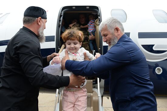 Children brought from Iraq are welcomed at Grozny airport