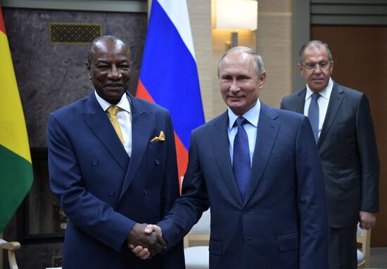 Russian President Vladimir Putin meets with President of Guinea Alpha Conde