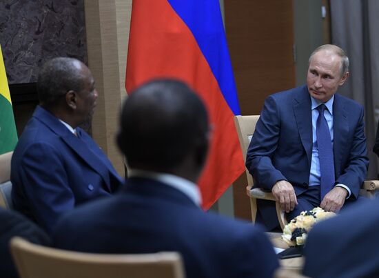 Russian President Vladimir Putin meets with President of Guinea Alpha Conde