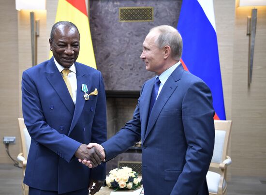 Russian President Vladimir Putin meets with President of Guinea Alpha Conde