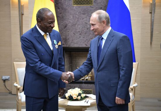 Russian President Vladimir Putin meets with President of Guinea Alpha Conde