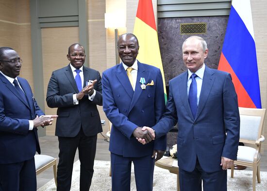 Russian President Vladimir Putin meets with President of Guinea Alpha Conde