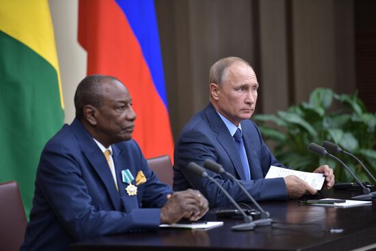 Russian President Vladimir Putin meets with President of Guinea Alpha Conde