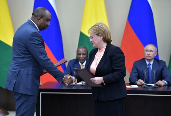 Russian President Vladimir Putin meets with President of Guinea Alpha Conde