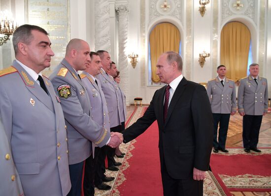 Russian President Vladimir Putin meets with senior officers at the Kremlin