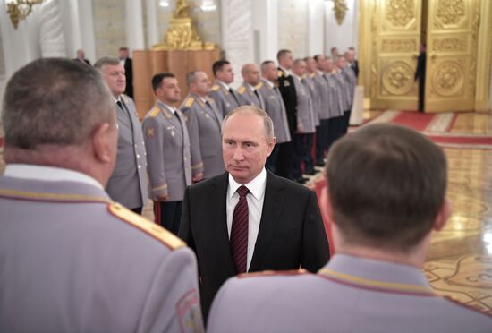 Russian President Vladimir Putin meets with senior officers at the Kremlin