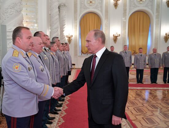 Russian President Vladimir Putin meets with senior officers at the Kremlin
