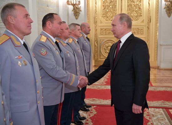 Russian President Vladimir Putin meets with senior officers at the Kremlin