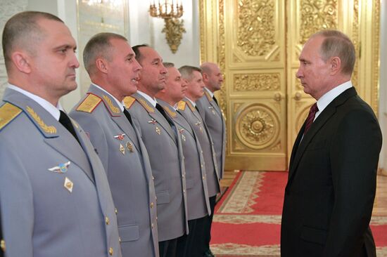 Russian President Vladimir Putin meets with senior officers at the Kremlin
