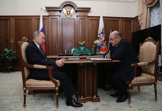 Russian President Vladimir Putin meets with FTS Head Mikhail Mishustin