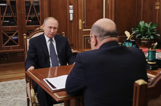 Russian President Vladimir Putin meets with FTS Head Mikhail Mishustin