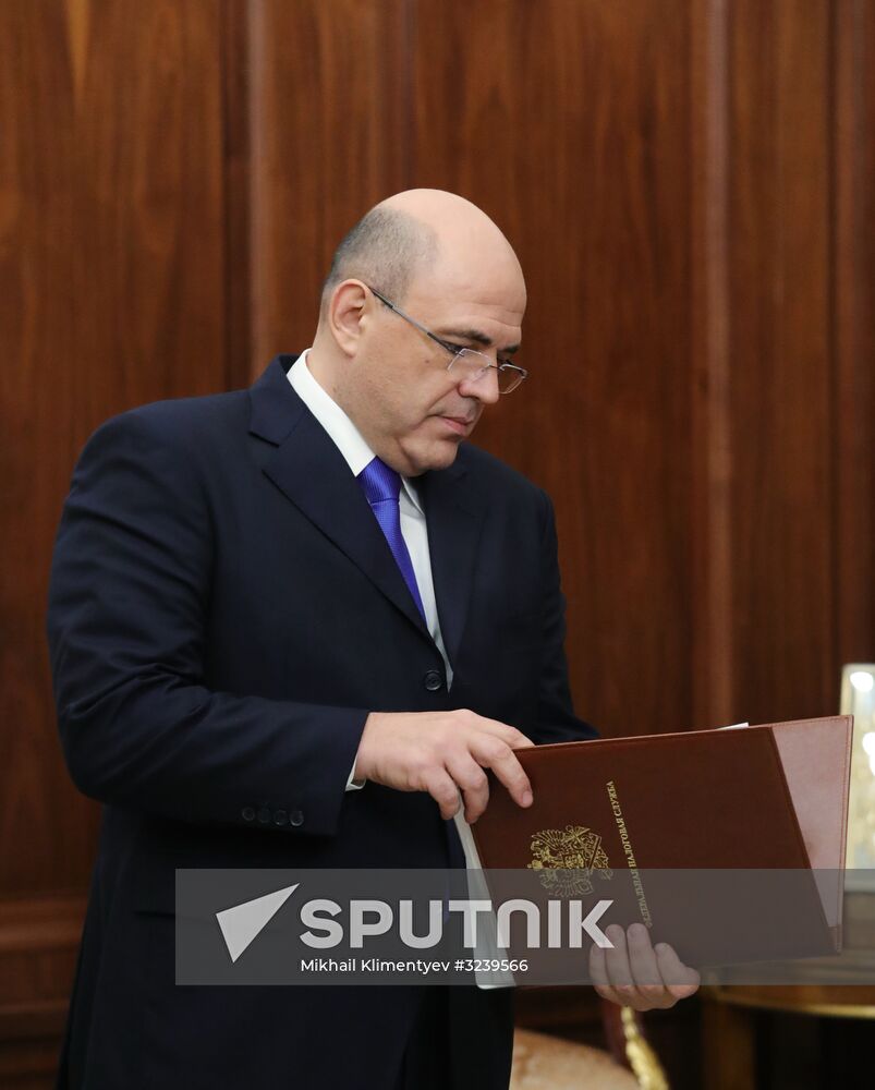 Russian President Vladimir Putin meets with FTS Head Mikhail Mishustin