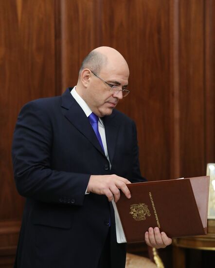 Russian President Vladimir Putin meets with FTS Head Mikhail Mishustin