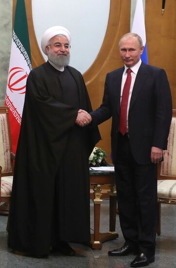 Russian President Vladimir Putin meets with Iranian President Hassan Rouhani