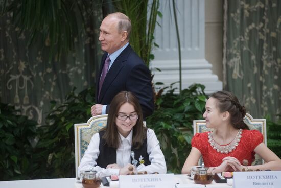 Russian President Vladimir Putin meets with winners of Family of the Year national contest