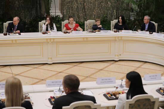 Russian President Vladimir Putin meets with winners of Family of the Year national contest