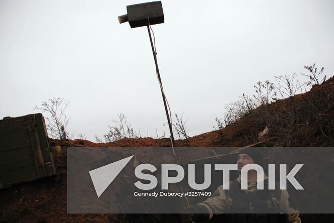 Donetsk People's Republic militia man of 1st company of the infantry battalion, 9th regiment of DPR Armed Forces Marine corps at the contact line with Ukrainian forces near Shirokino village. Location: Ukraine, Donetsk region. Author: Gennady Dubovoy/Sputnik. Donetsk People's Republic contact line sitrep