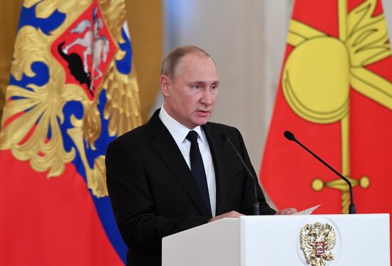 Russian President Vladimir Putin meets with service personnel who took part in counter-terrorism operation in Syria