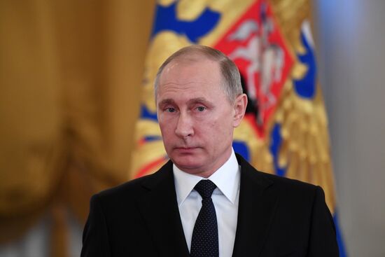 Russian President Vladimir Putin meets with service personnel who took part in counter-terrorism operation in Syria
