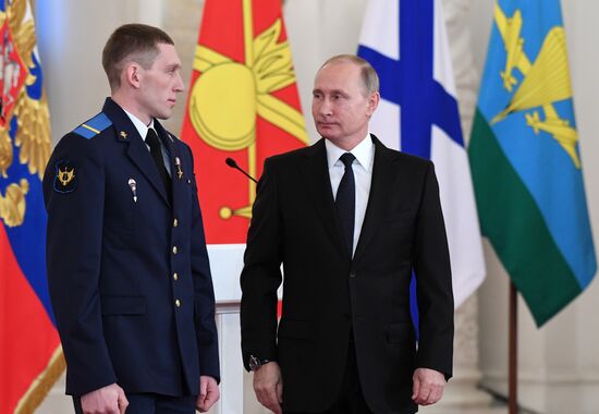 Russian President Vladimir Putin meets with service personnel who took part in counter-terrorism operation in Syria