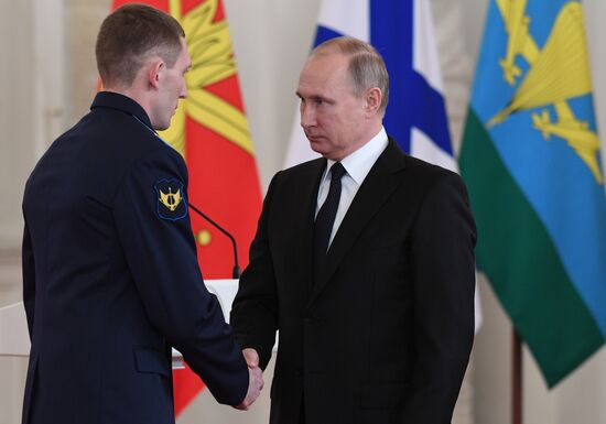 Russian President Vladimir Putin meets with service personnel who took part in counter-terrorism operation in Syria