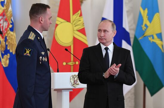 Russian President Vladimir Putin meets with service personnel who took part in counter-terrorism operation in Syria