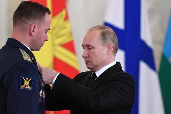 Russian President Vladimir Putin meets with service personnel who took part in counter-terrorism operation in Syria