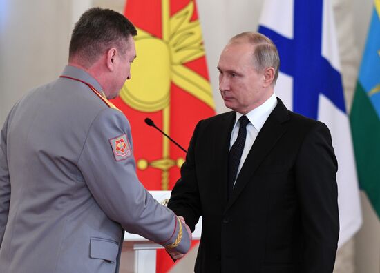 Russian President Vladimir Putin meets with service personnel who took part in counter-terrorism operation in Syria
