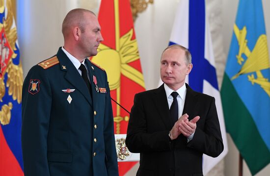Russian President Vladimir Putin meets with service personnel who took part in counter-terrorism operation in Syria