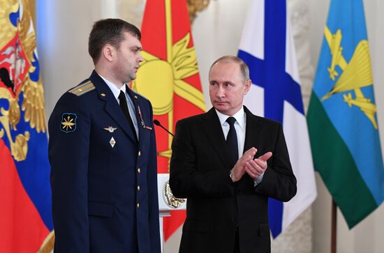Russian President Vladimir Putin meets with service personnel who took part in counter-terrorism operation in Syria