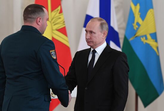 Russian President Vladimir Putin meets with service personnel who took part in counter-terrorism operation in Syria