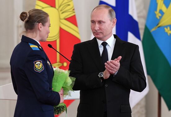 Russian President Vladimir Putin meets with service personnel who took part in counter-terrorism operation in Syria